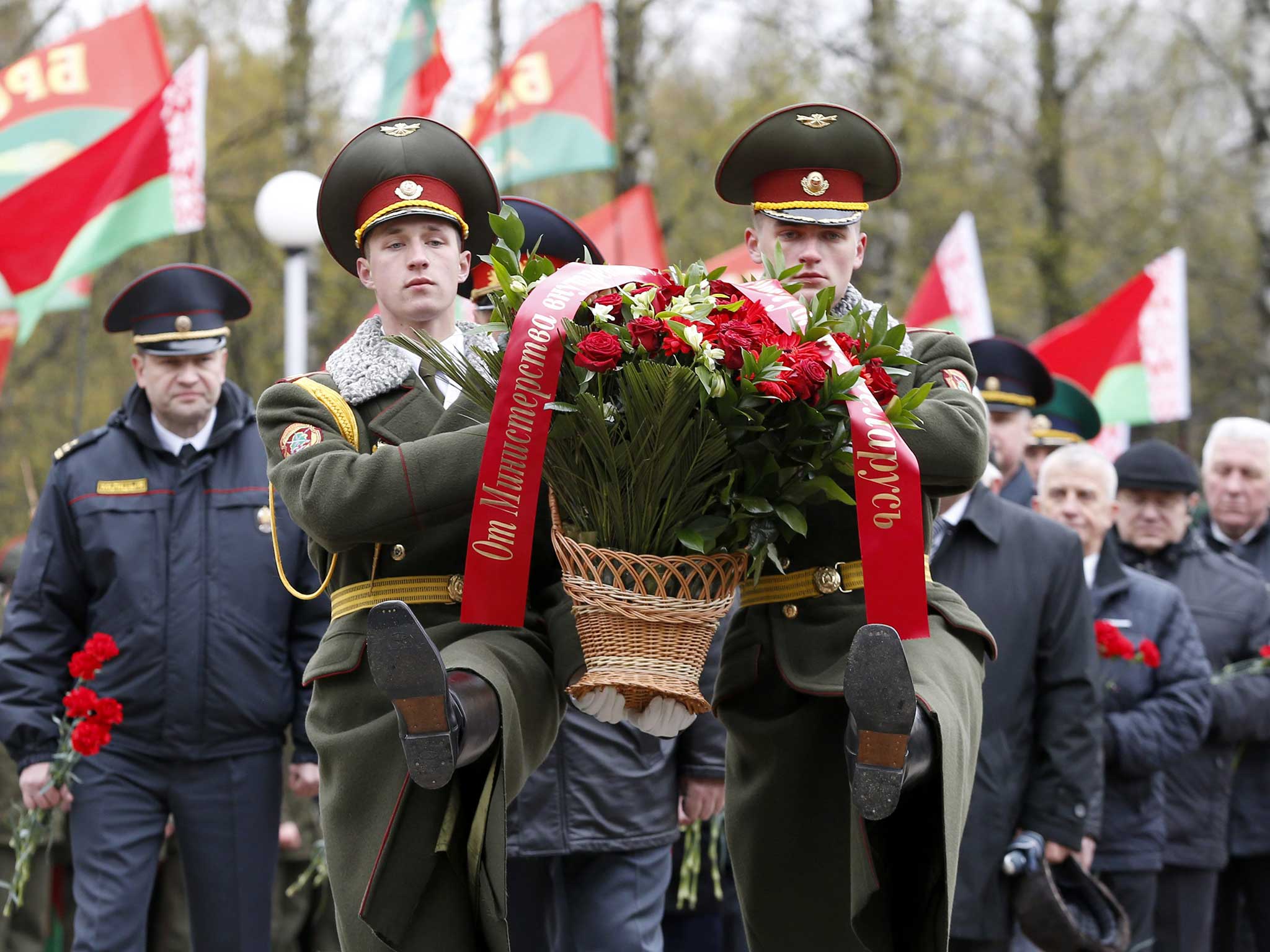 Belarussian soldiers of an honor guard carry wreaths during a memorial service for the victims of the Chernobyl disaster in Minsk