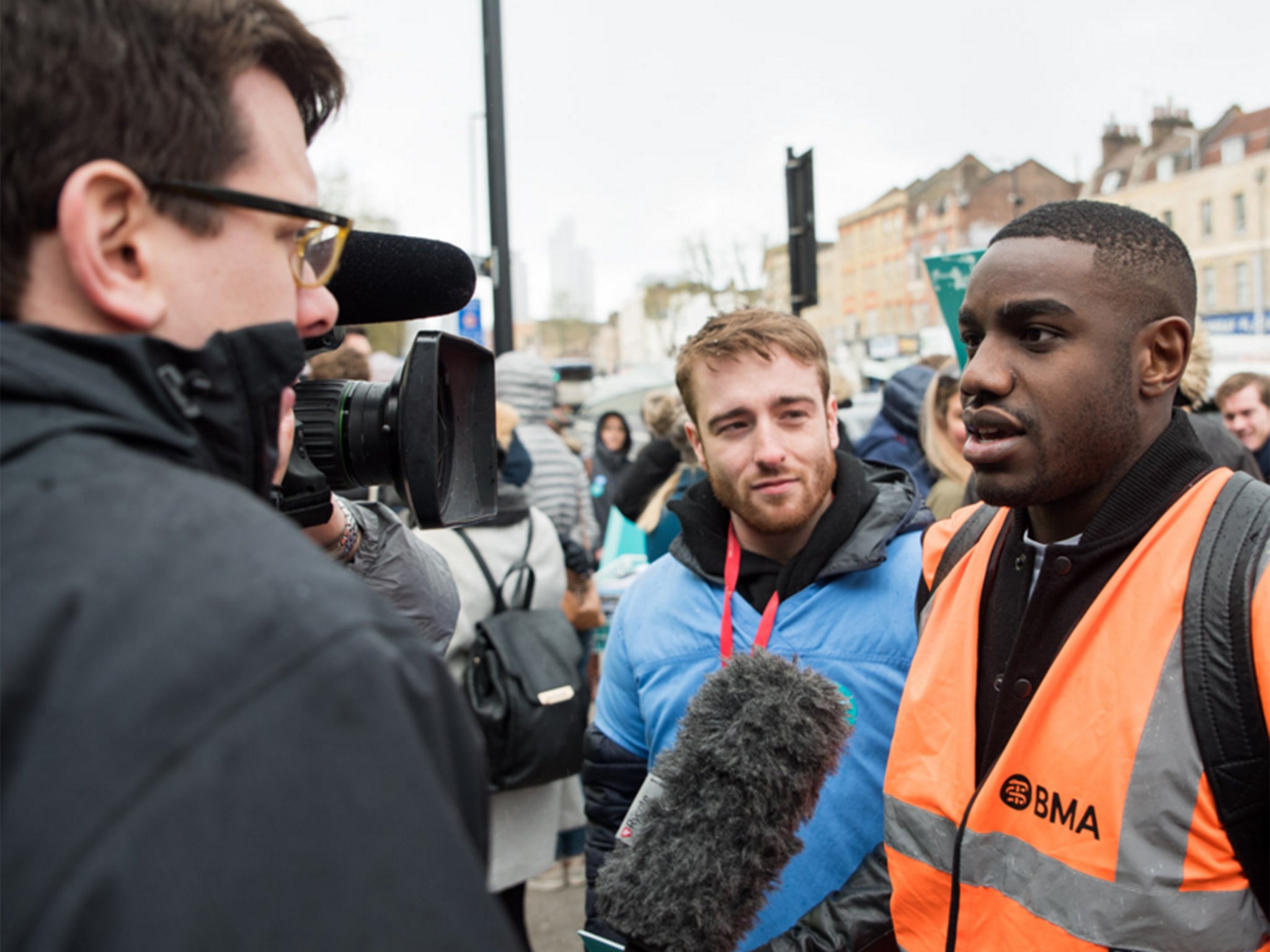 A junior doctor gives his views to a television news reporter