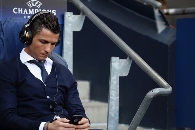 Cristiano Ronaldo on his phone before the start of the match