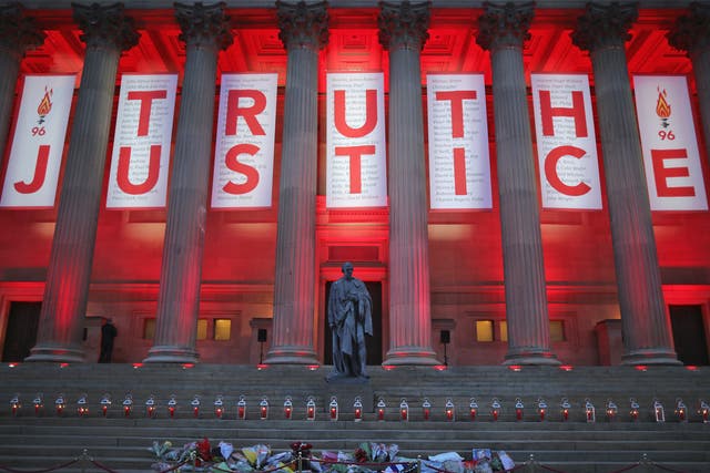 A banner reading 'Truth' and 'Justice' hangs from Liverpool's Saint George's Hall
