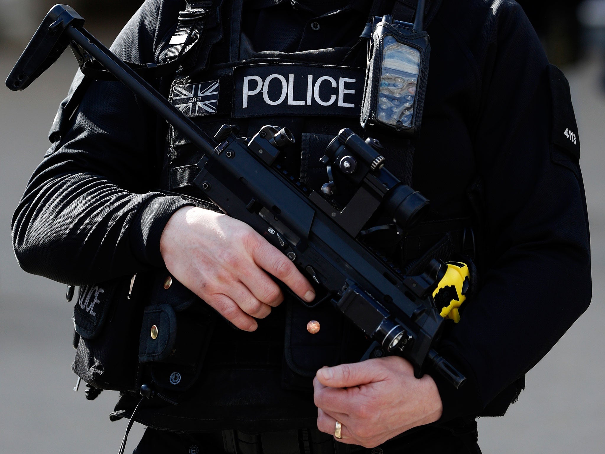 An armed British police officer holds his automatic weapon as he stands on duty in central London on March 22, 2016. B