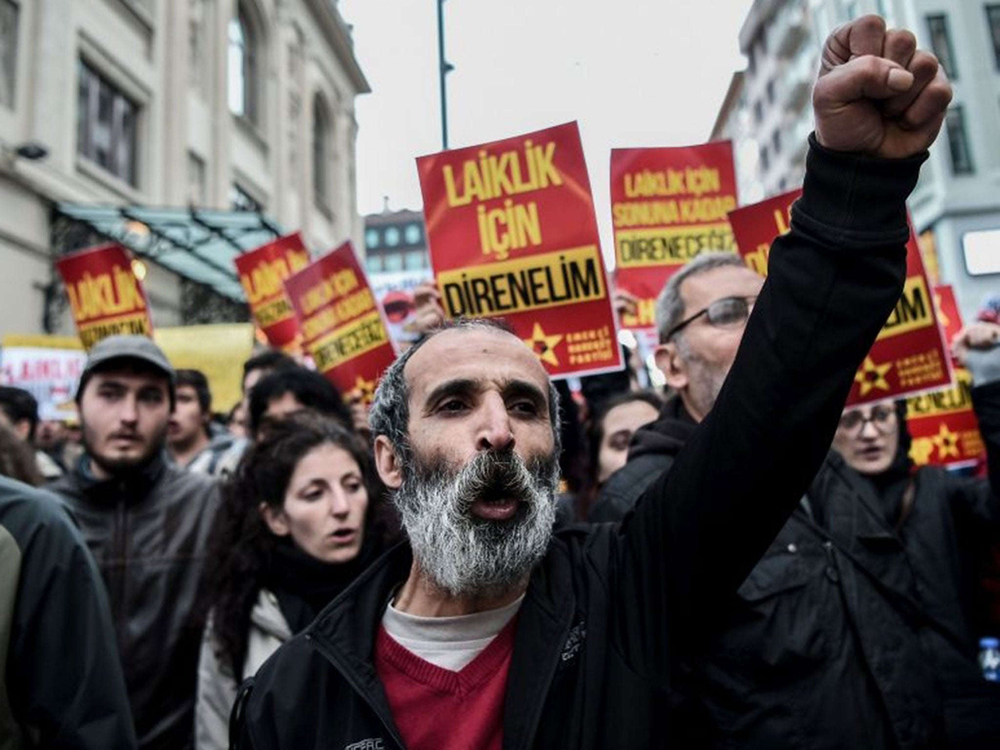 Protesters shout slogans and hold placards reading 'We will resist for secularism' on 26 April, 2016, at Kadikoy district in Istanbul, during a protest against a call for the country to adopt a religious constitution