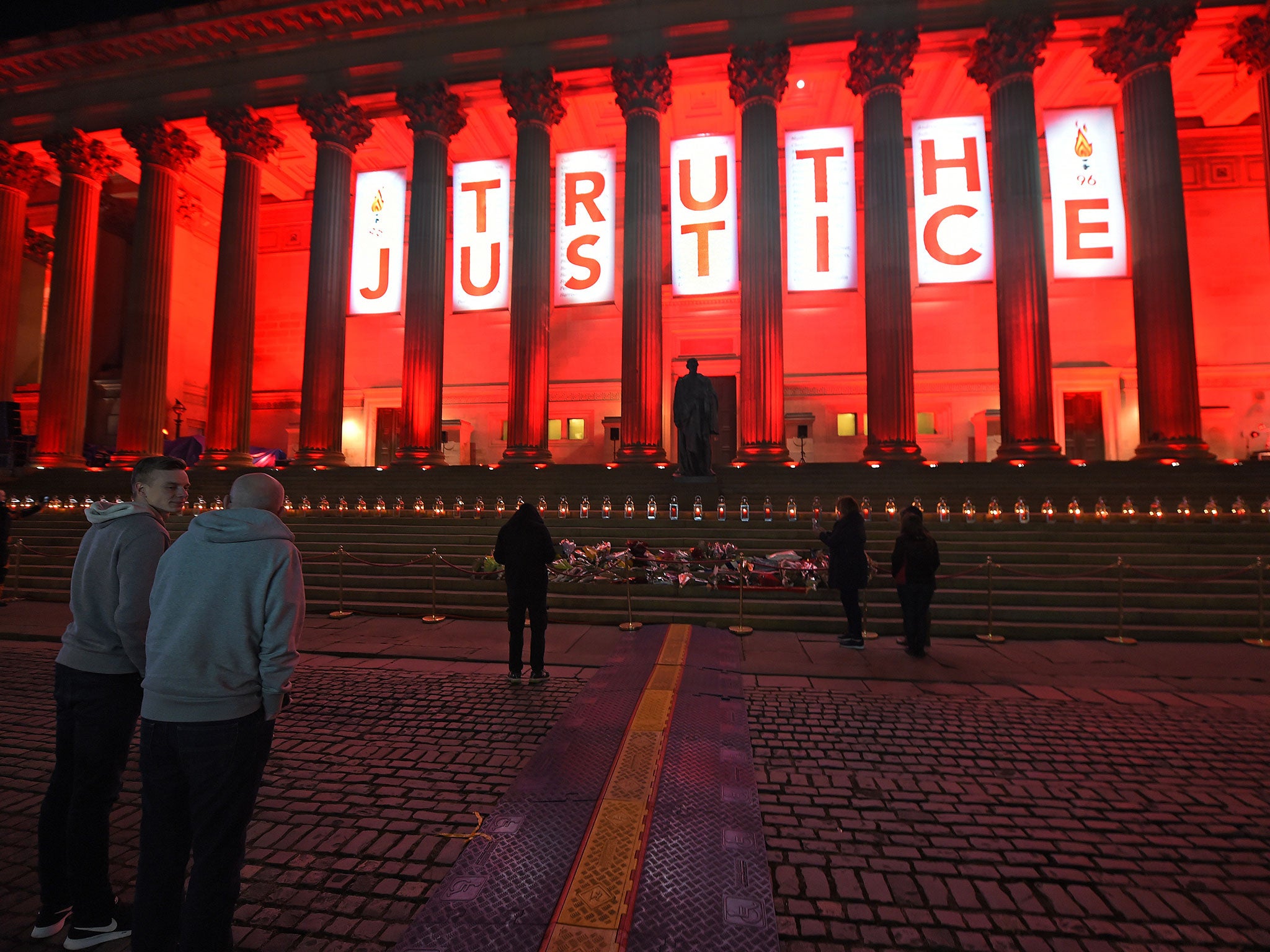Liverpools St Georges Hall is lit up Red and a banner wth Truth and Justice is hung after the verdict of unlawful killing at the Hillsborough Inquest is anounced at the Coroners Court
