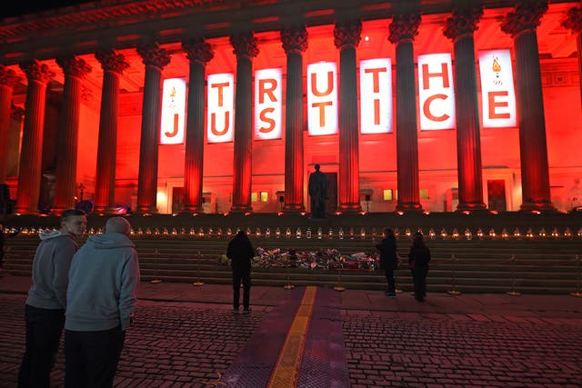 Liverpools St Georges Hall is lit up Red and a banner wth Truth and Justice is hung after the verdict of unlawful killing at the Hillsborough Inquest is anounced at the Coroners Court