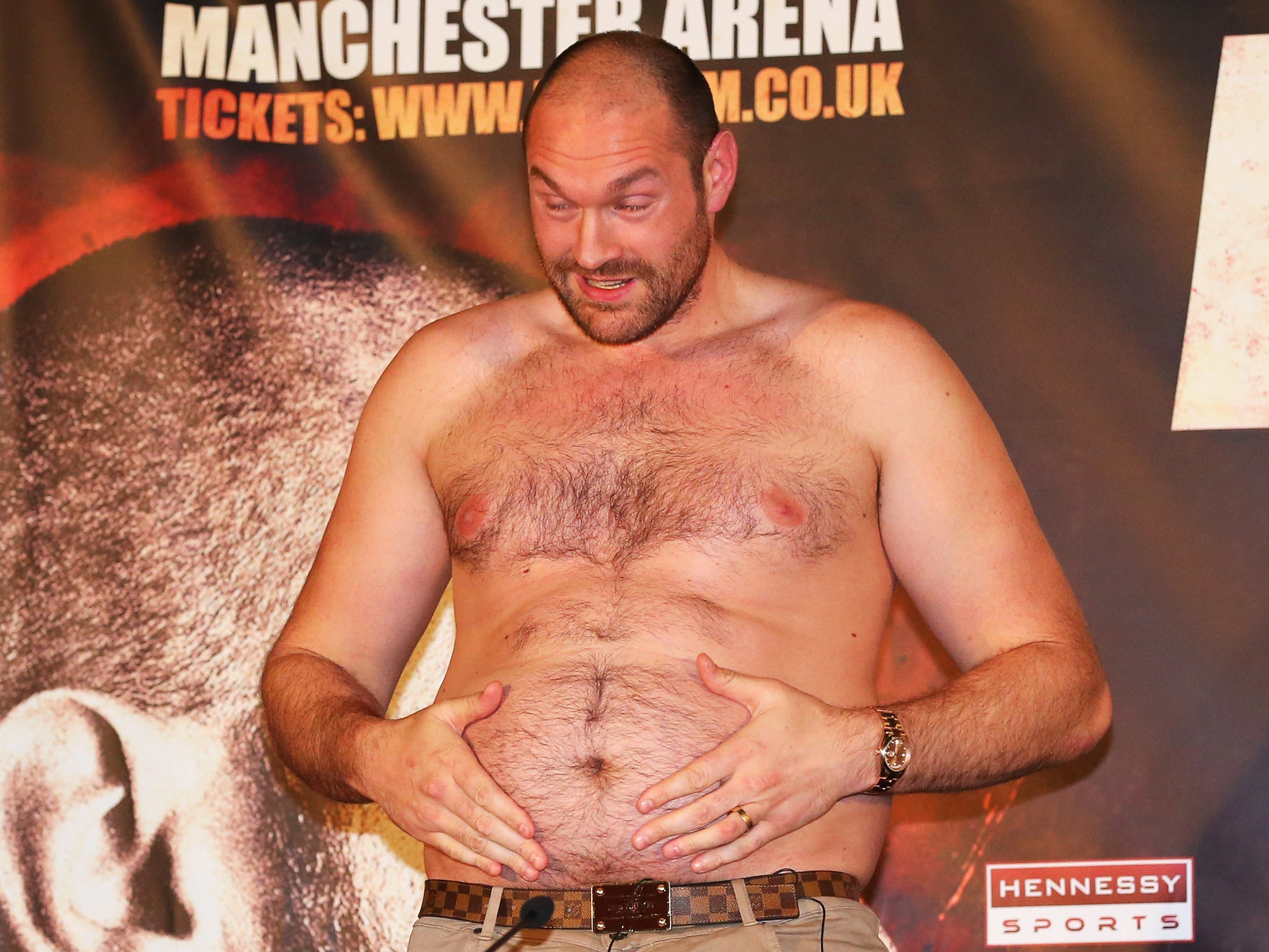 &#13;
Fury removed his top to display his physique to Wladimir Klitschko at Wednesday's pre-fight press conference (Getty )&#13;