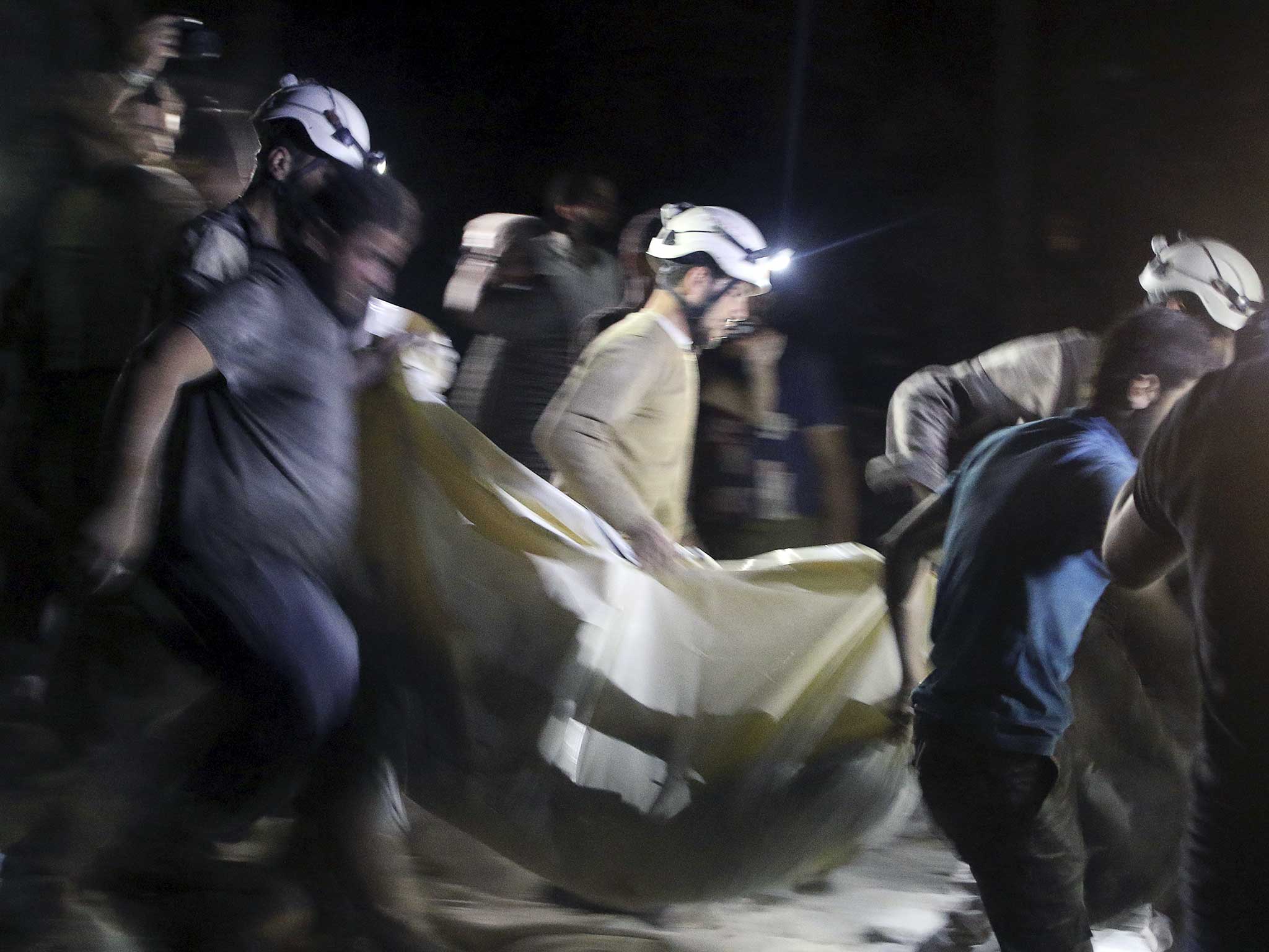 Civil defence members carry a casualty after an air strike at a field hospital in the rebel held area of al-Sukari district of Aleppo
