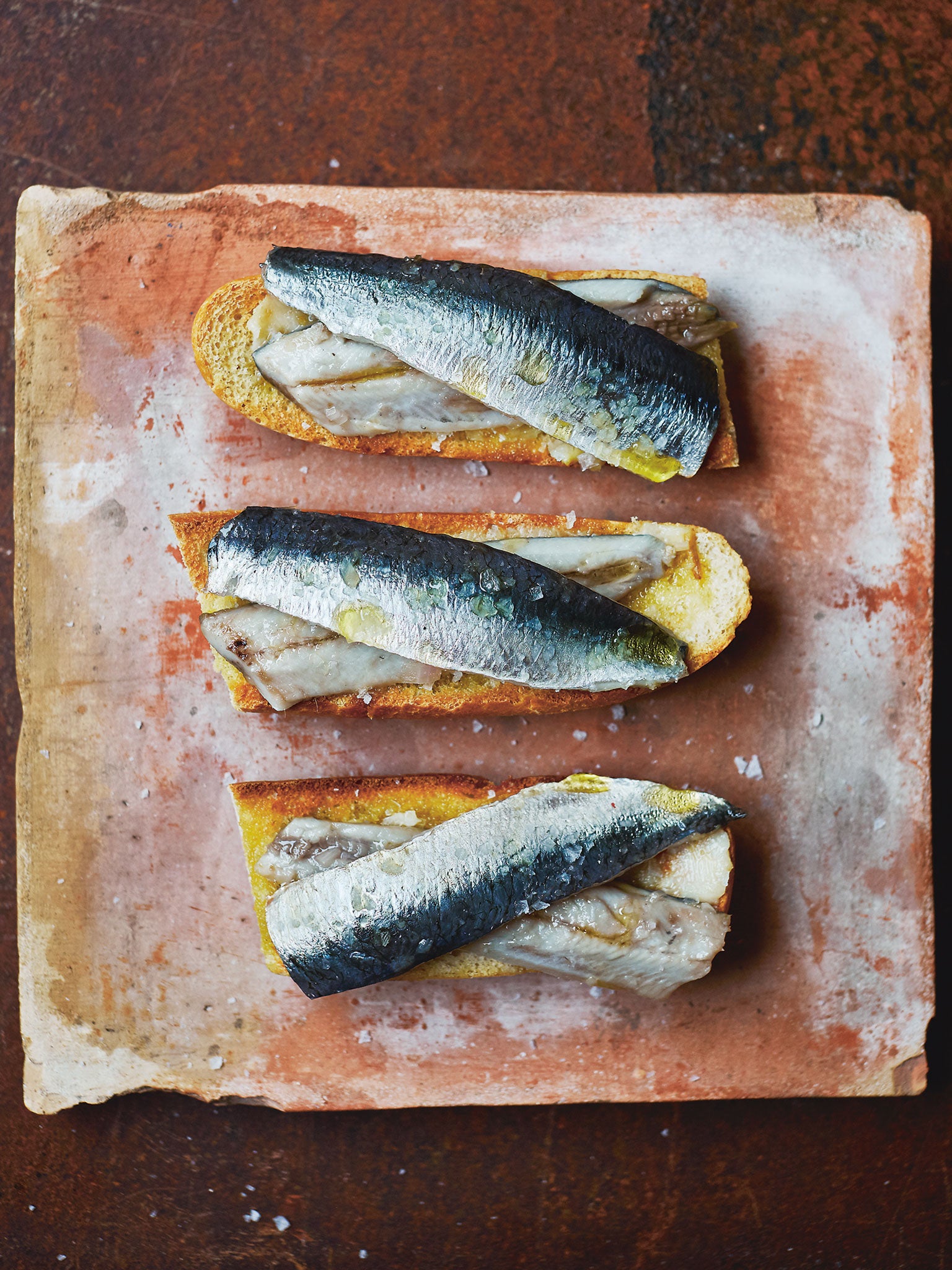 Serve the marinated sardines on a toasted baguette