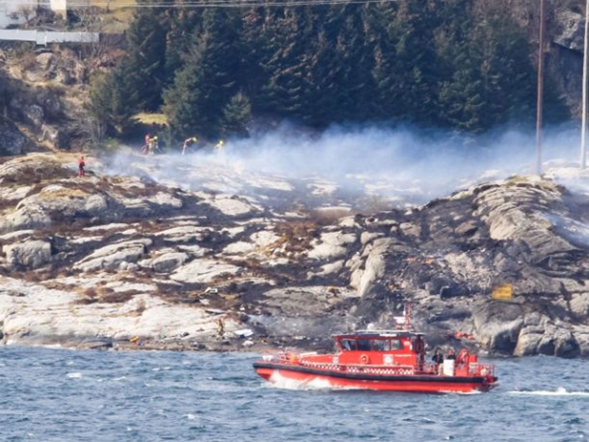 Rescue forces work at the shore west of Bergen, Norway after a helicopter transporting 13 workers from an offshore oil field in the North Sea crashed off on 29 April, 2016