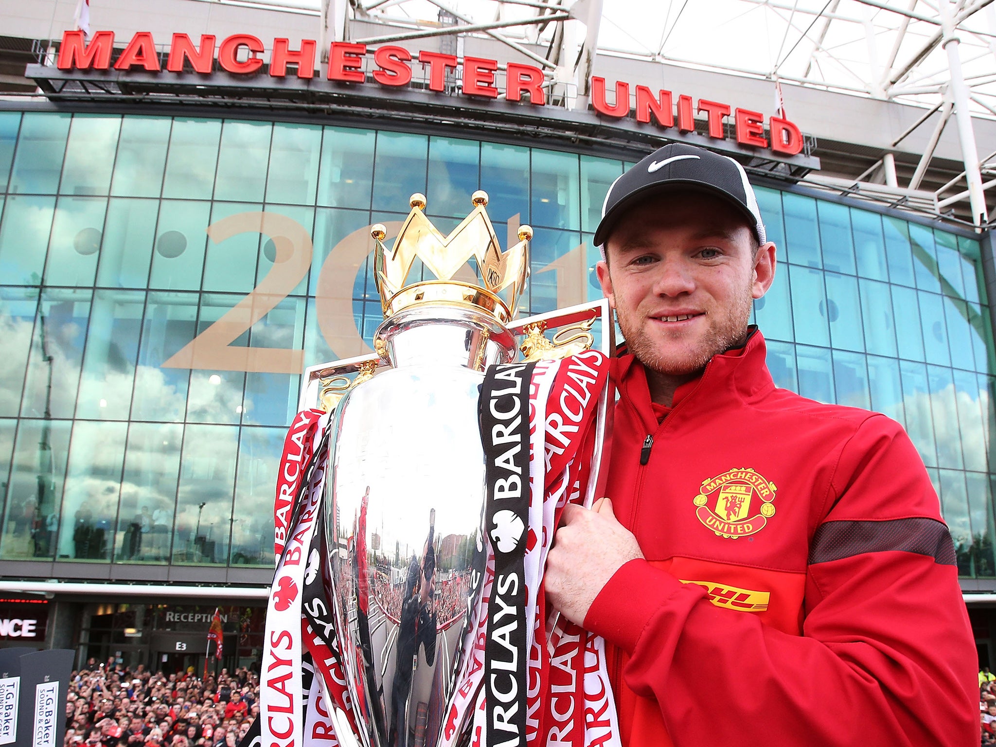 Rooney poses with the Premier League trophy outside Old Trafford in 2013