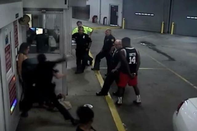 The officer was captured punching the woman on video