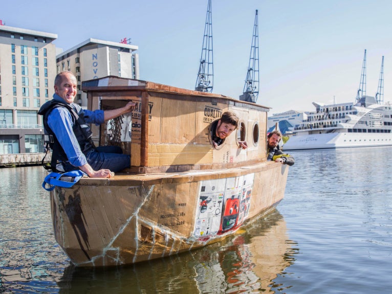 Kevin McCloud sailing in the cardboard houseboat on the River Thames