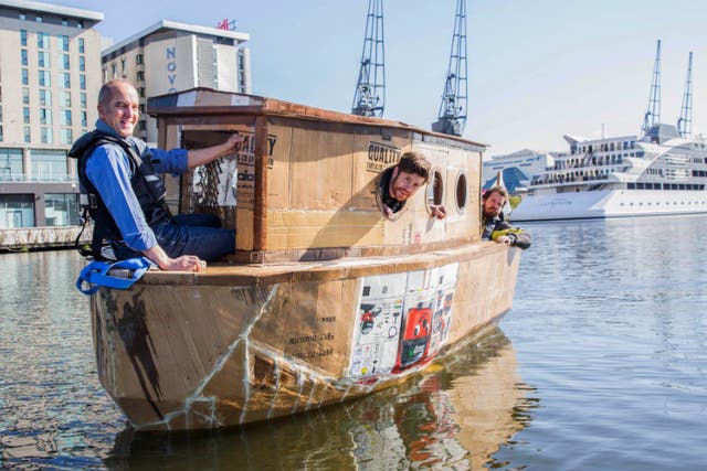 Kevin McCloud sailing in the cardboard houseboat on the River Thames