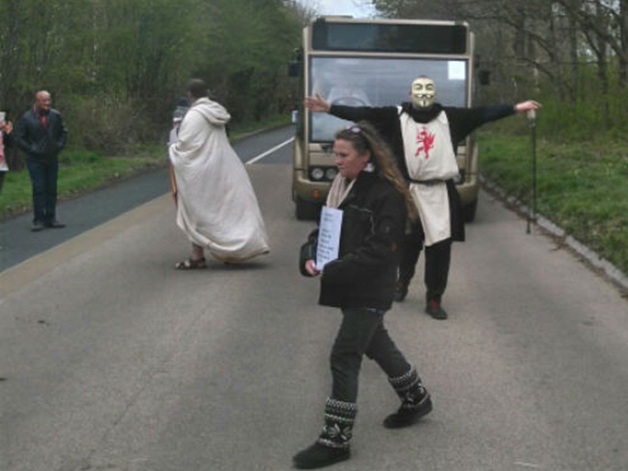 A druid protests in front of one of English Heritage's coaches