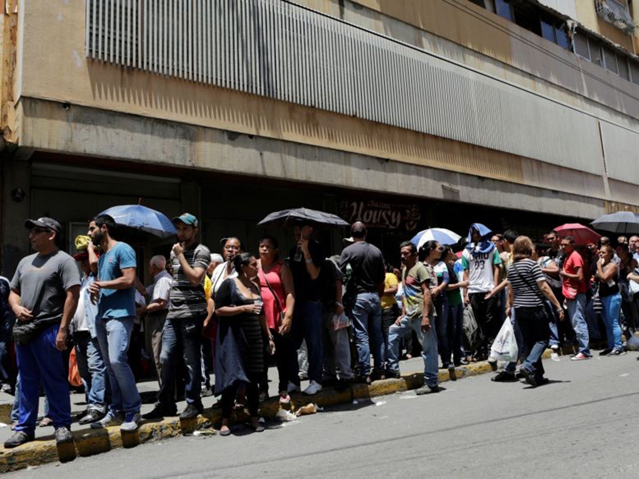 People queuing to buy basic foodstuffs in Caracas, Venezuela