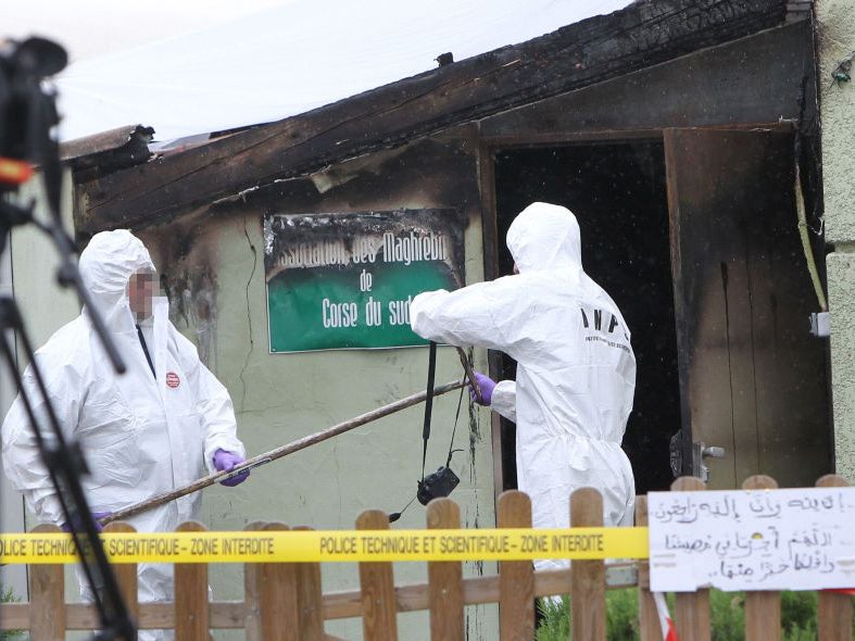 French forensics work in front of a Muslim prayer room after it was destroyed by a fire, suspected to be arson in Ajaccio