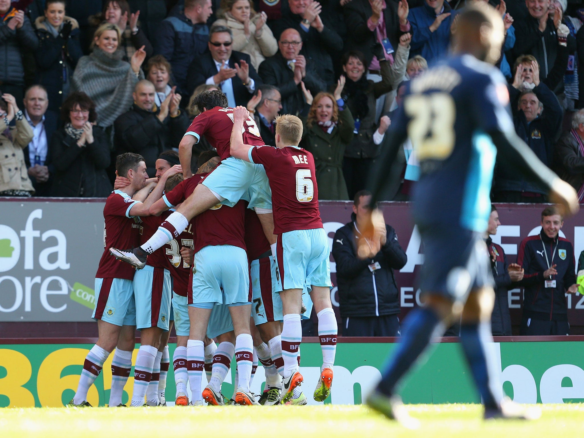 Sam Vokes is mobbed by his Burnley team-mates after scoring the winner against QPR