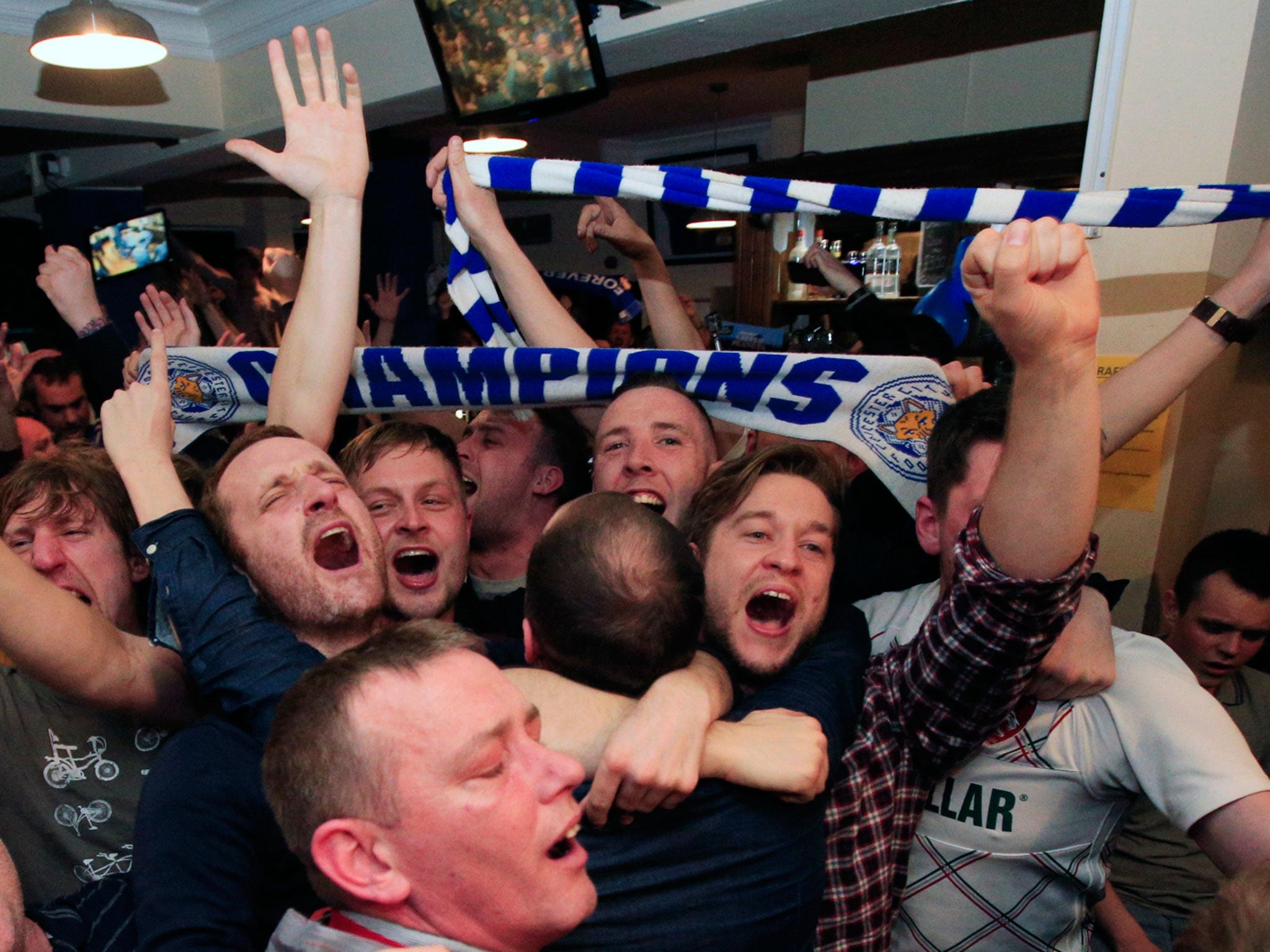 Leicester City fans celebrate in the Market Tavern in Leicester
