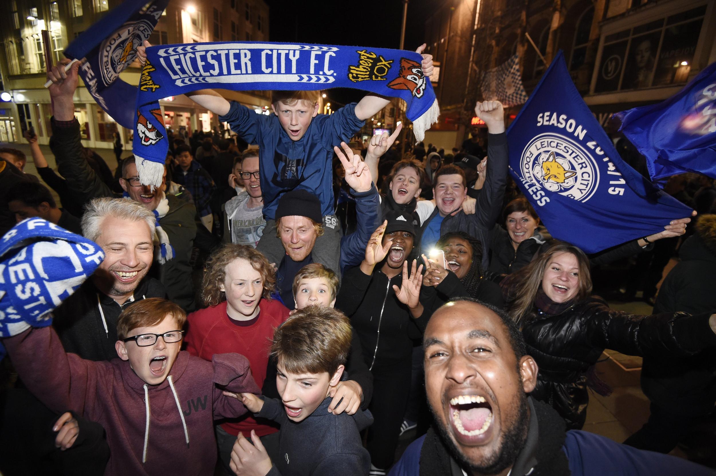 Leicester City supporters celebrate at the city's Haymarket Memorial Clock Tower