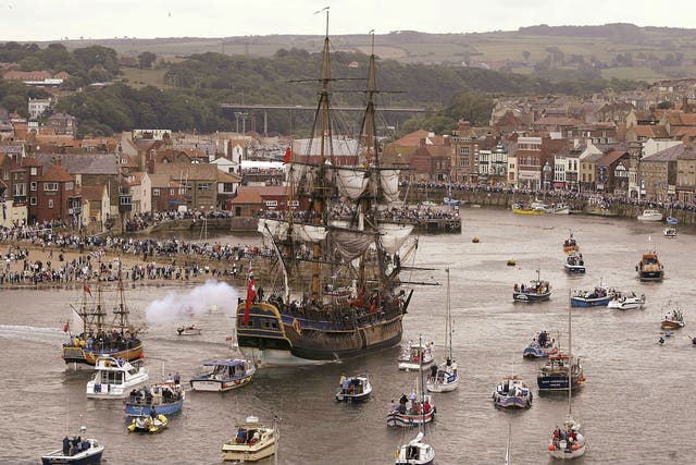 A replica of the Endeavour sailing into Whitby harbour