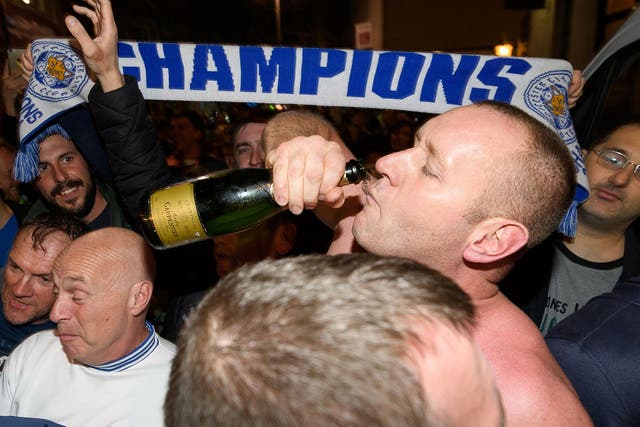 Leicester fans celebrate the club's Premier League success on Monday night