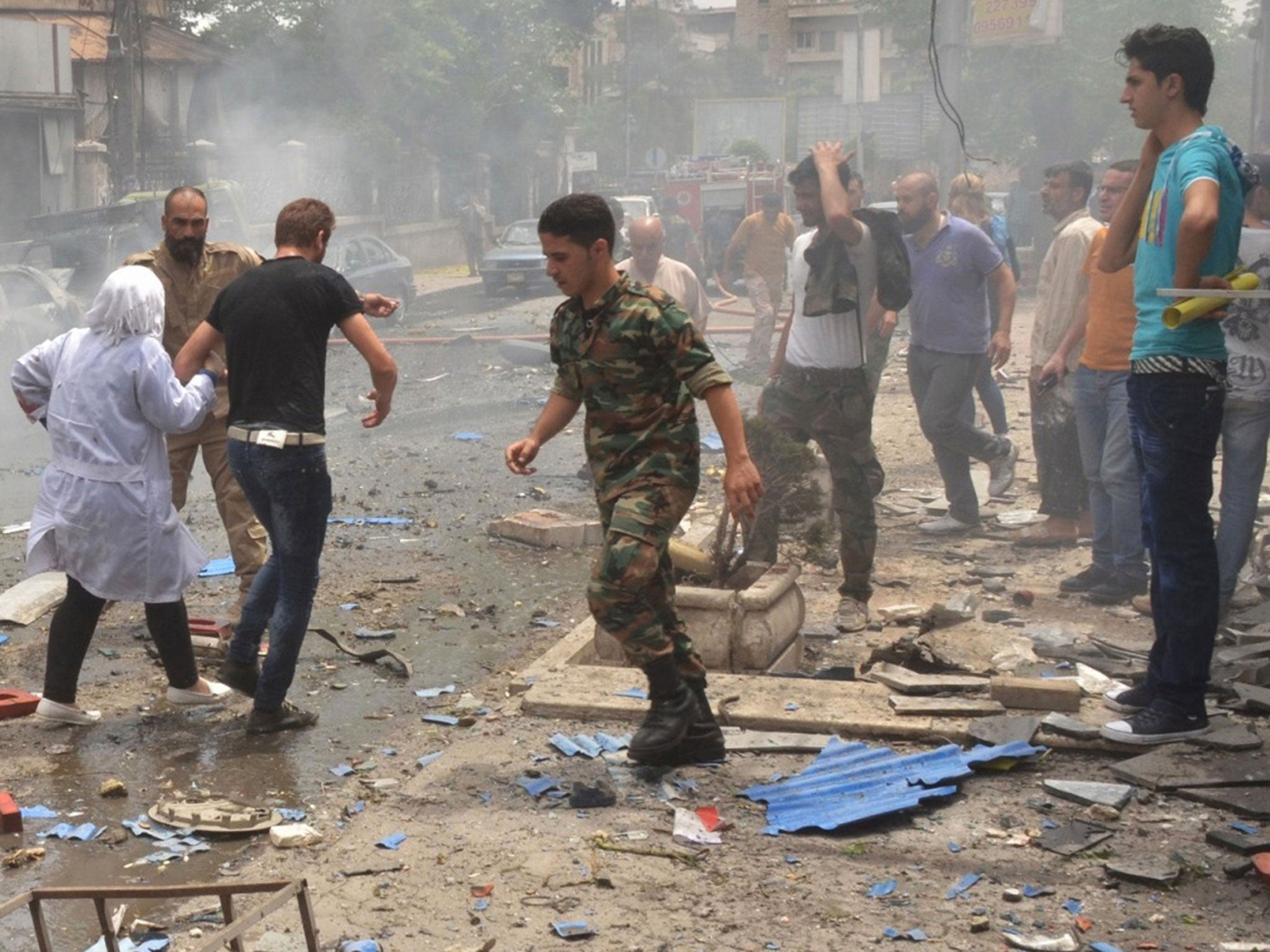 &#13;
Syrian security forces evacuate medical staff after rockets reportedly fired by rebels hit Al-Dabbit hospital in government-controlled neighbourhood of Muhafaza in the northern city of Aleppo on May 3, 2016. &#13;