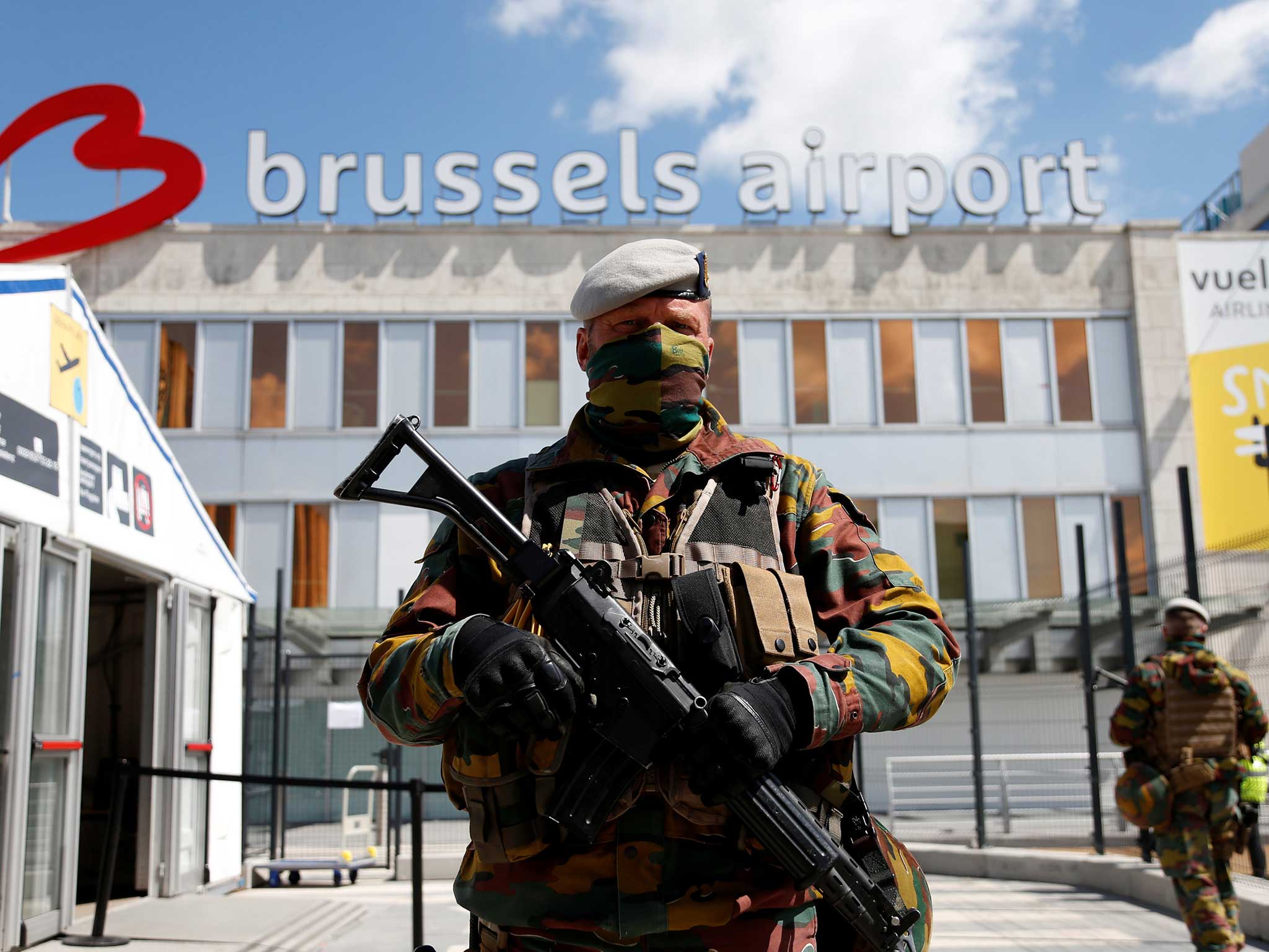 A Belgian soldier stands guard outside the partially reopened departure hall of Zaventem international airport near Brussels, Belgium