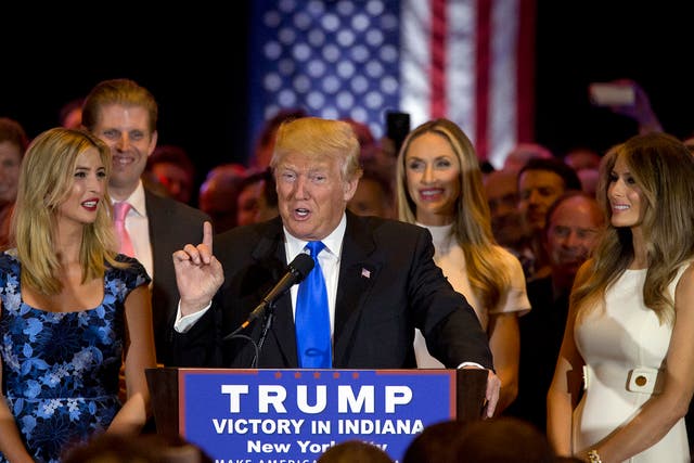 Donald Trump joined by his wife Melania, right, daughter Ivanka, left, and son Eric, background left, as he speaks during news conference after his Indiana win