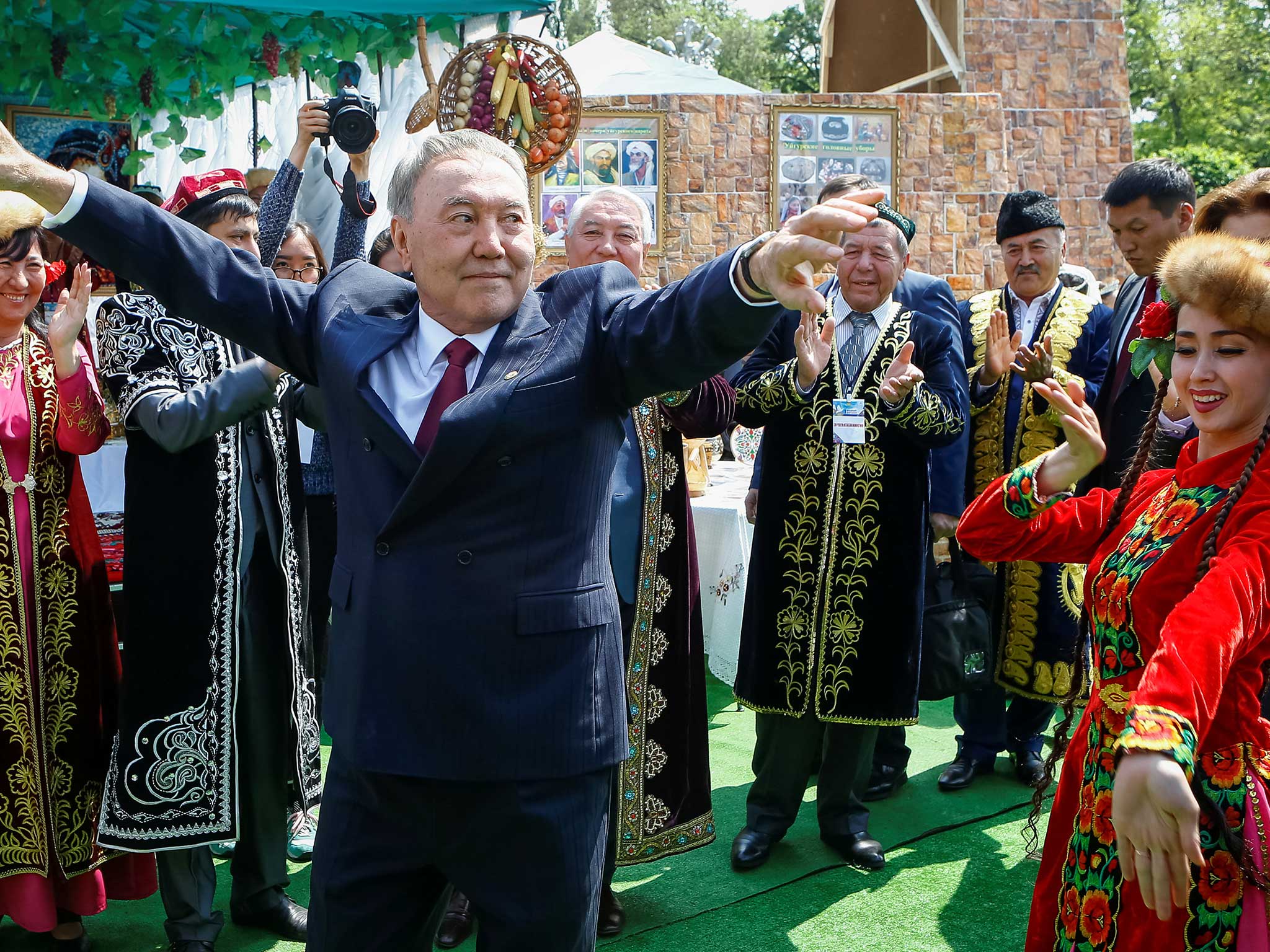 Kazakhstan's President Nursultan Nazarbayev dances with artists during celebrations to mark Kazakhstan People's Unity Day in Almaty, Kazakhstan