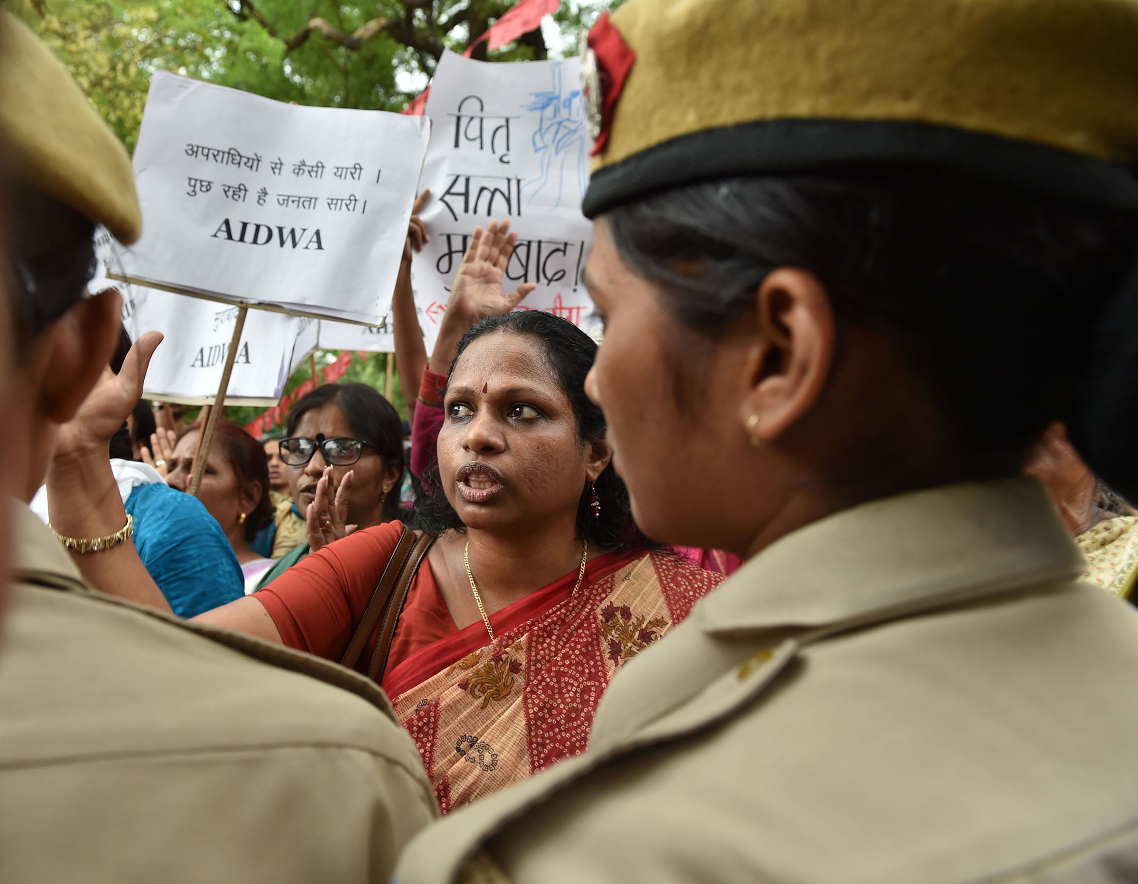 Indian activists shout slogans as they are confronted by police officials during a protest outside Kerala House in New Delhi