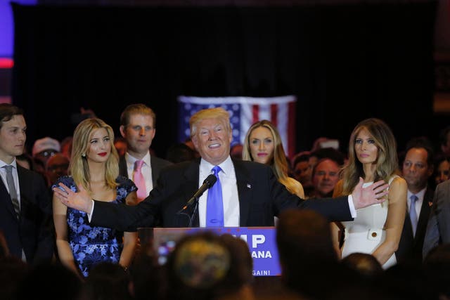 Republican US presidential candidate Donald Trump speaks, alongside his son-in-law, daughter and wife