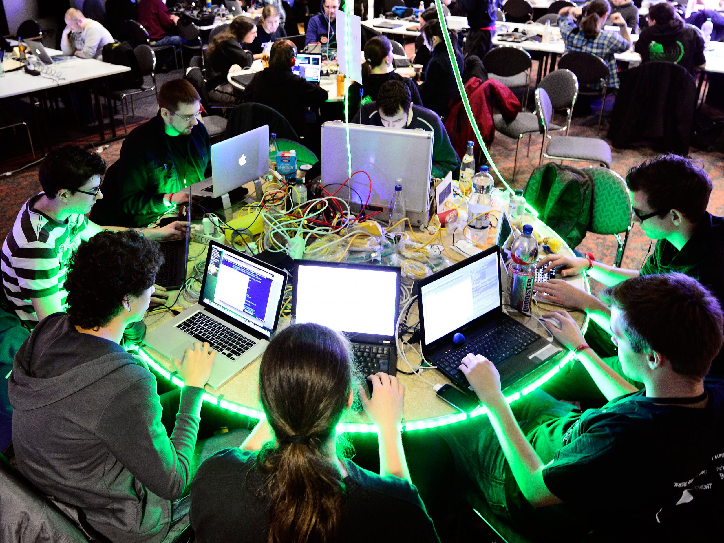 Participants work at their laptops at the annual Chaos Computer Club (CCC) computer hackers' congress in Hamburg in 2012