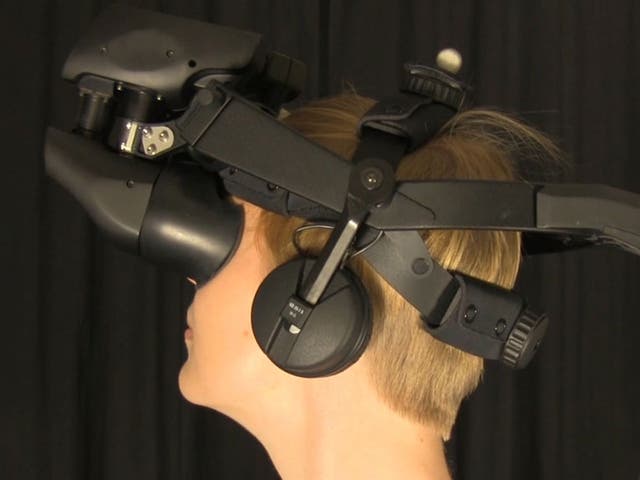 A woman uses one of the VR headsets used in the tests