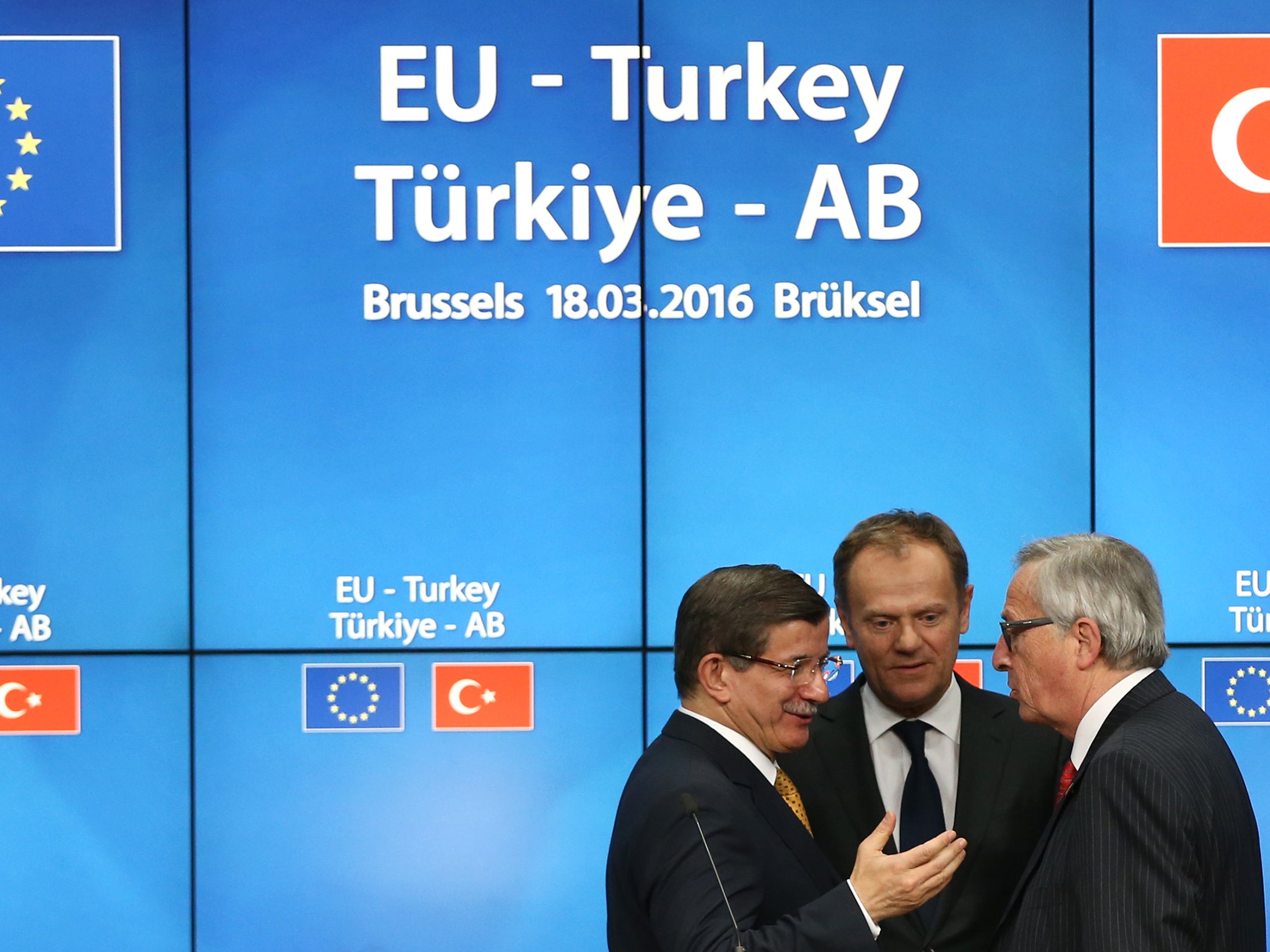Turkey's Prime Minister, Ahmet Davutoglu (L) shakes hands with President of the European Council, Donald Tusk (C) and President of the European Commission, Jean-Claude Juncker, after a press conference to discuss the migrant deal reached between Turkey and EU states (Getty Images )