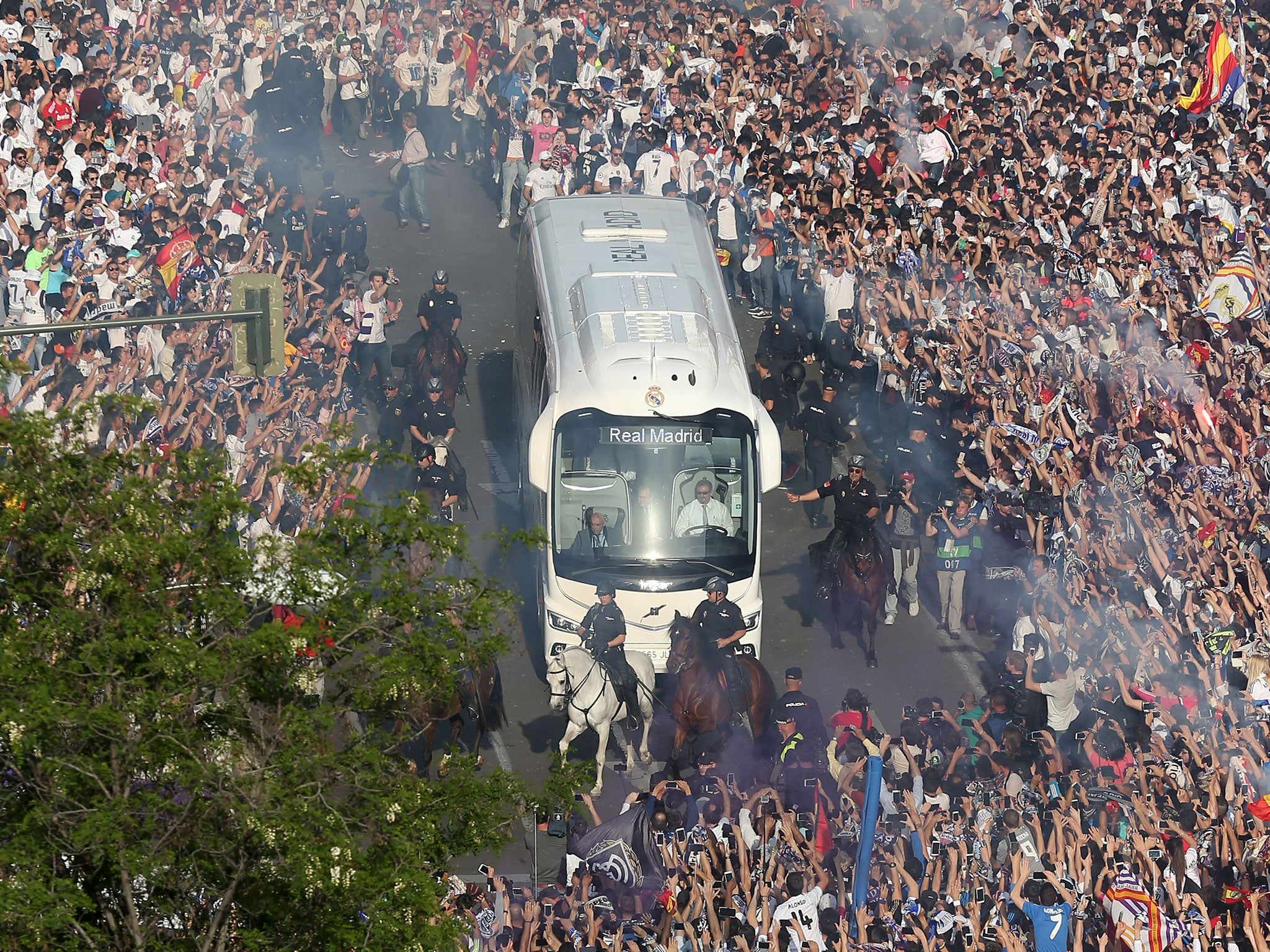 Real Madrid fans welcome their team to the Bernabeu