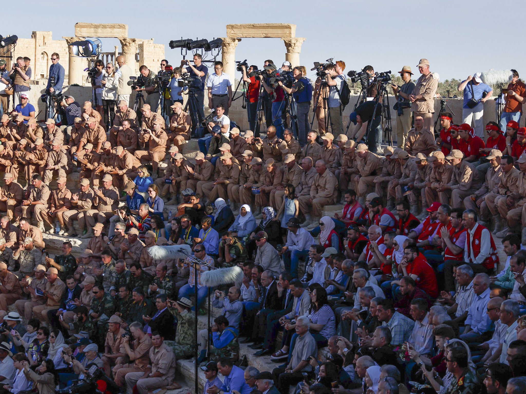 Russian soldiers and invited guests listen the Mariinsky Symphony Orchestra concert at Palmyra amphitheatre on 5 May 2016