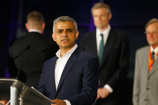 Sadiq Khan speaks at City Hall after being confirmed as London's new mayor, with Britain First's Paul Golding turning his back