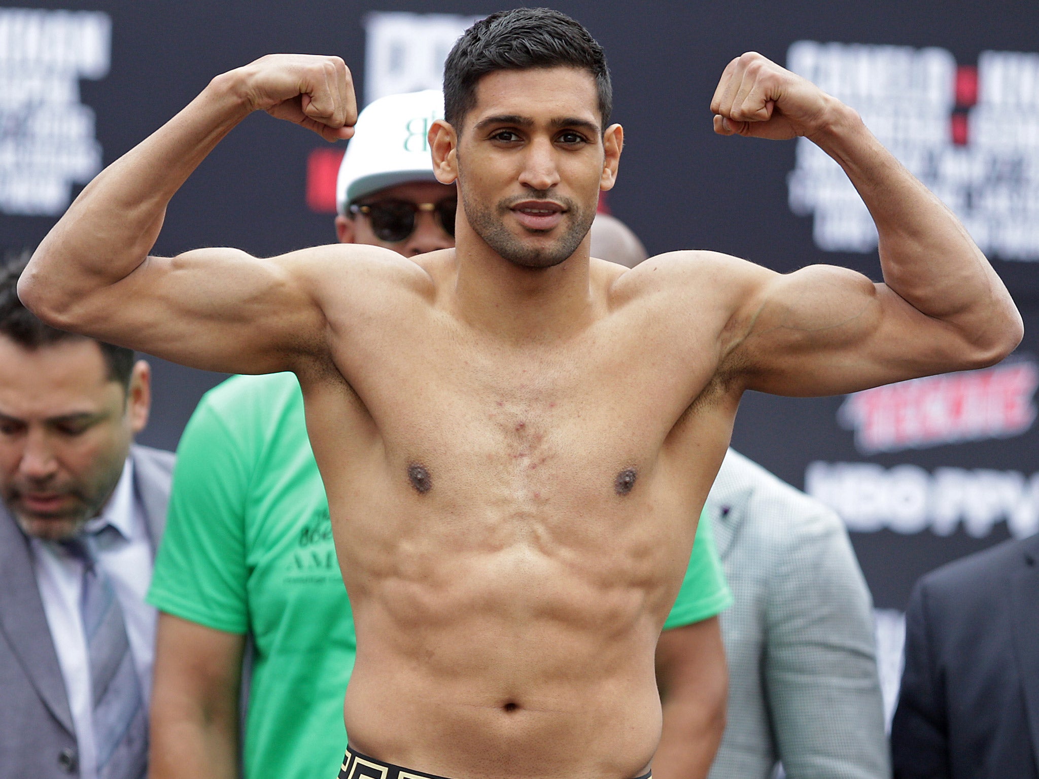 Amir Khan poses after weighing in for his bout with Saul Alvarez