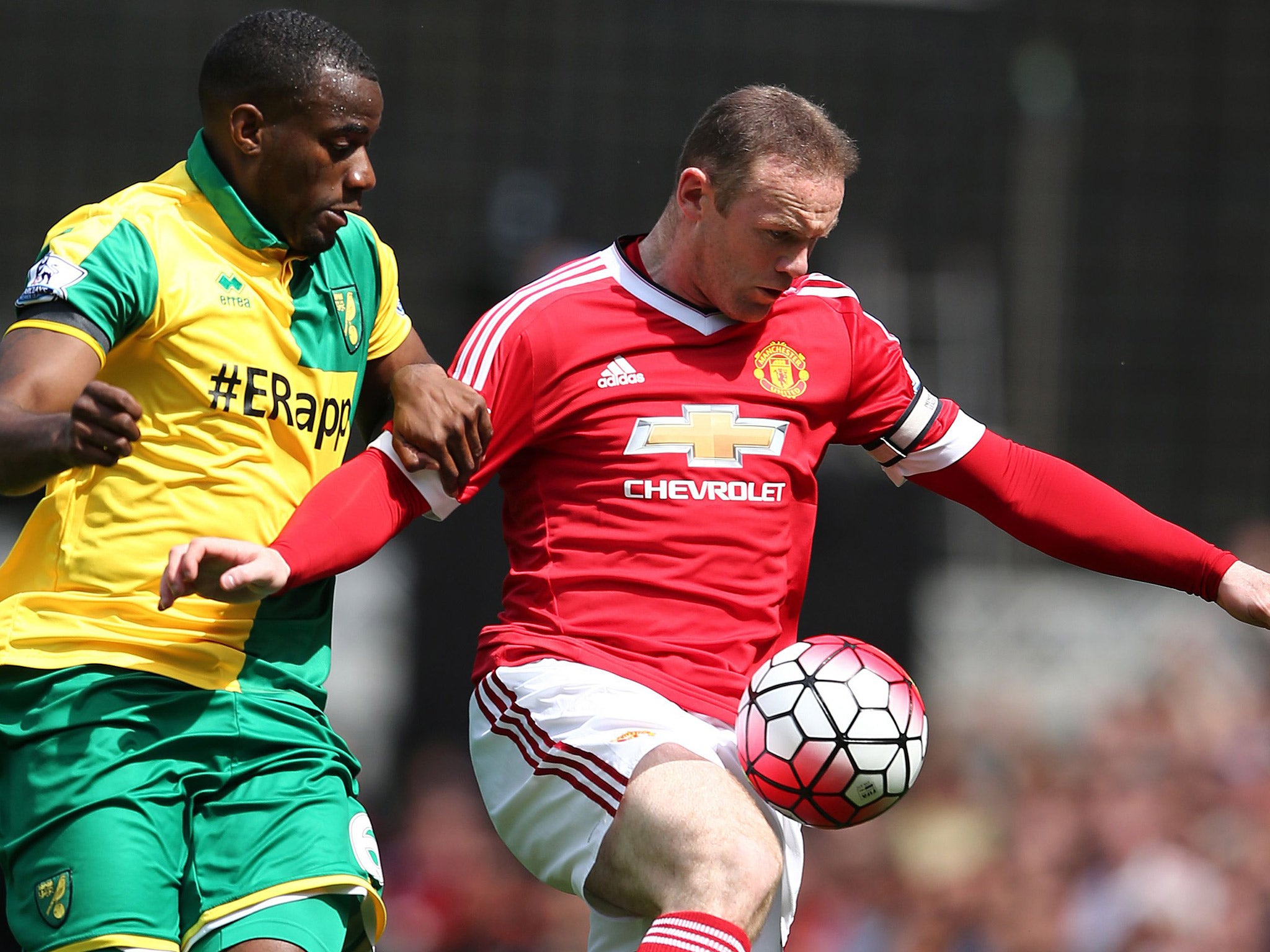 Wayne Rooney battles with Norwich defender Sebastian Bassong