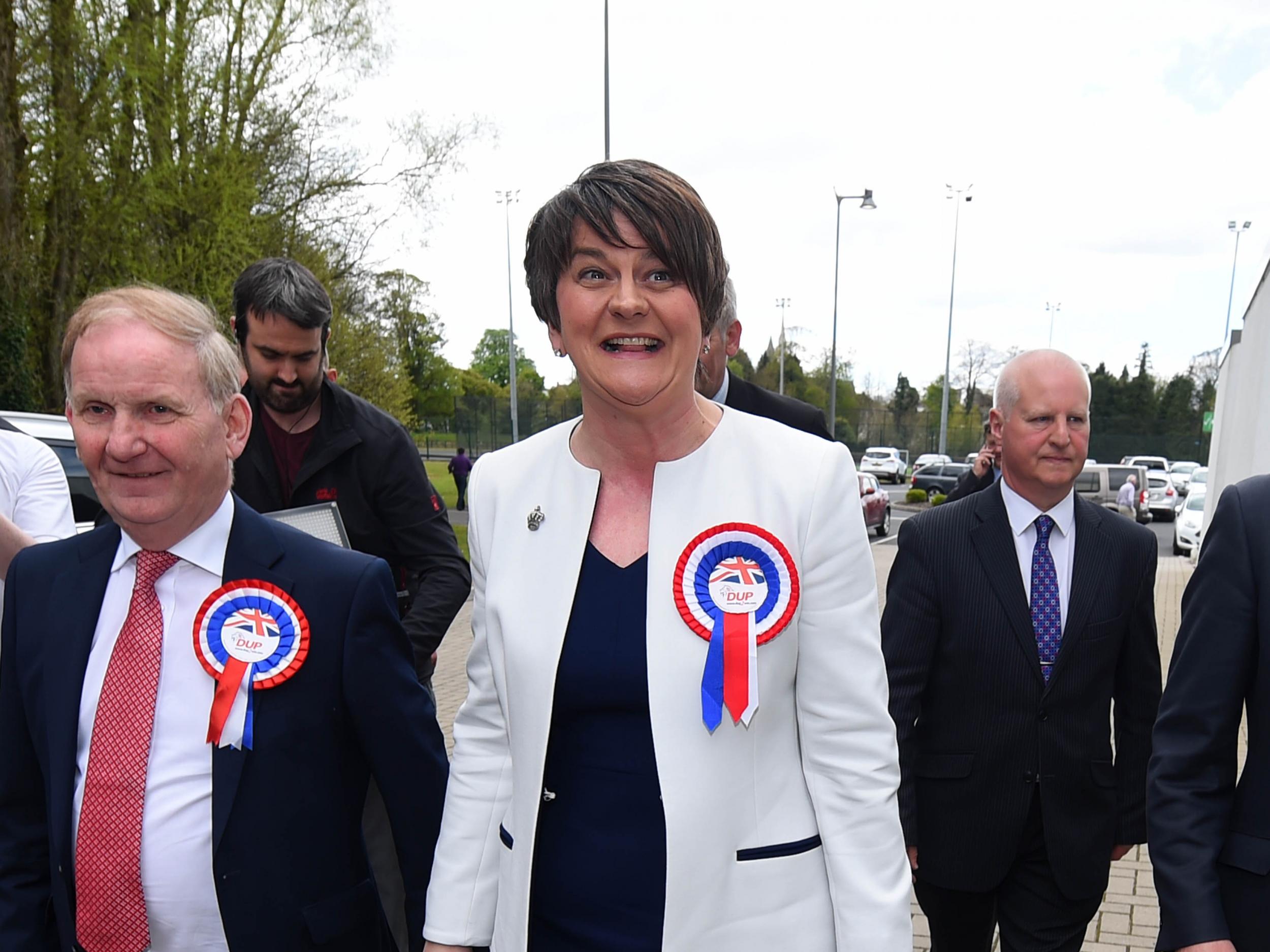 DUP leader Arlene Foster is welcomed by party members as she arrives at the Northern Ireland Assembly elections count