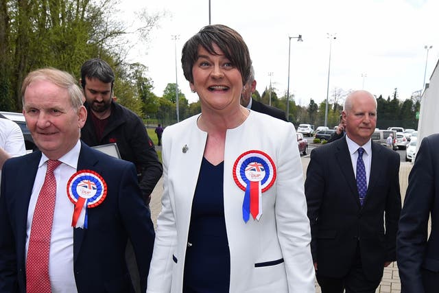 DUP leader Arlene Foster is welcomed by party members as she arrives at the Northern Ireland Assembly elections count