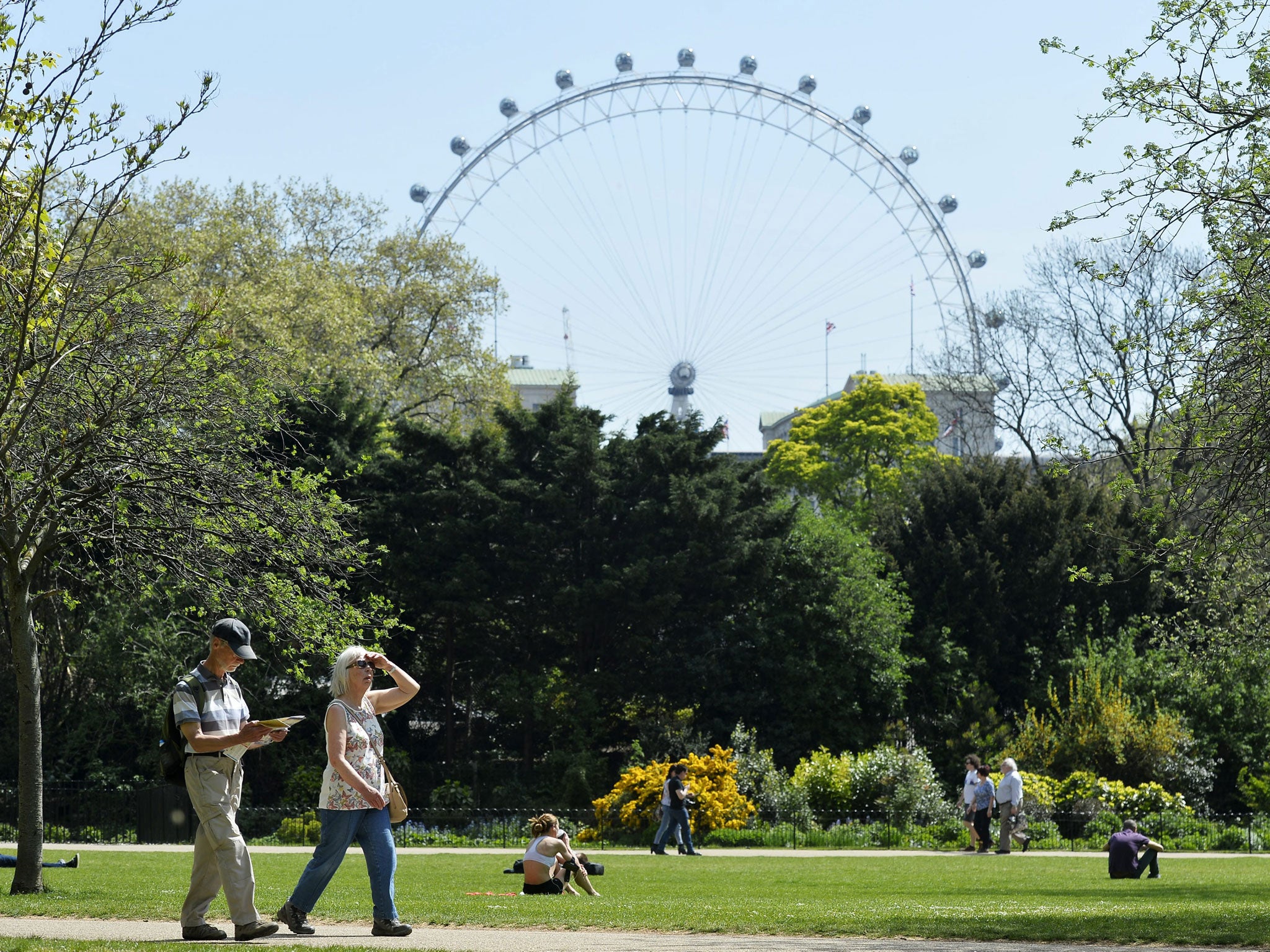 People walk through St James's Park in central London