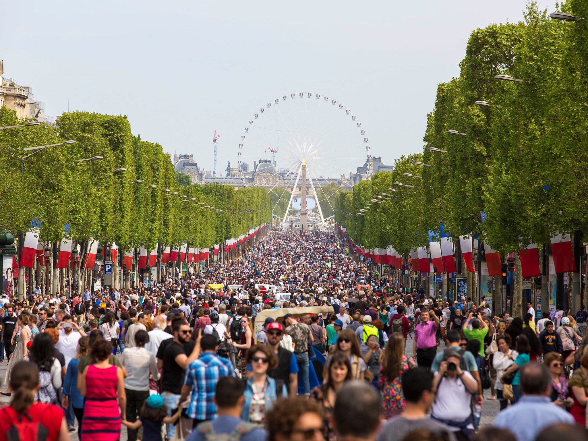People gather on the Champs-Elysees boulevard in Paris