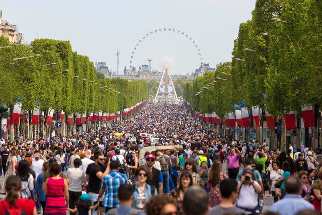 People gather on the Champs-Elysees boulevard in Paris