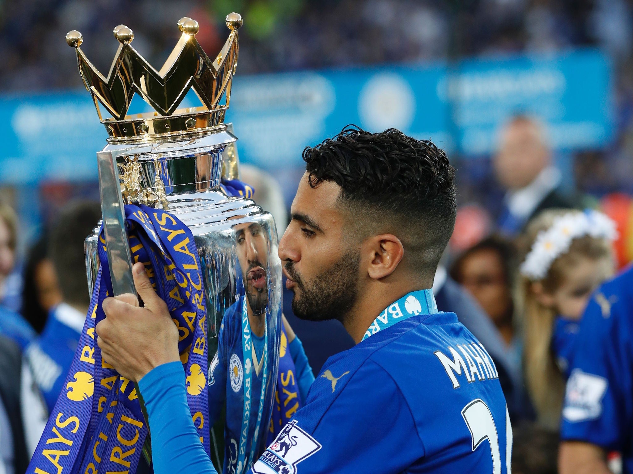 Leicester's Riyad Mahrez gets his hands on the Premier League trophy