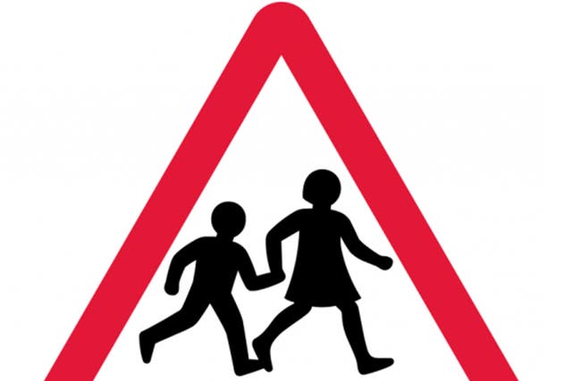 The updated sign by Margaret Calvert, which shows more defined features on the children