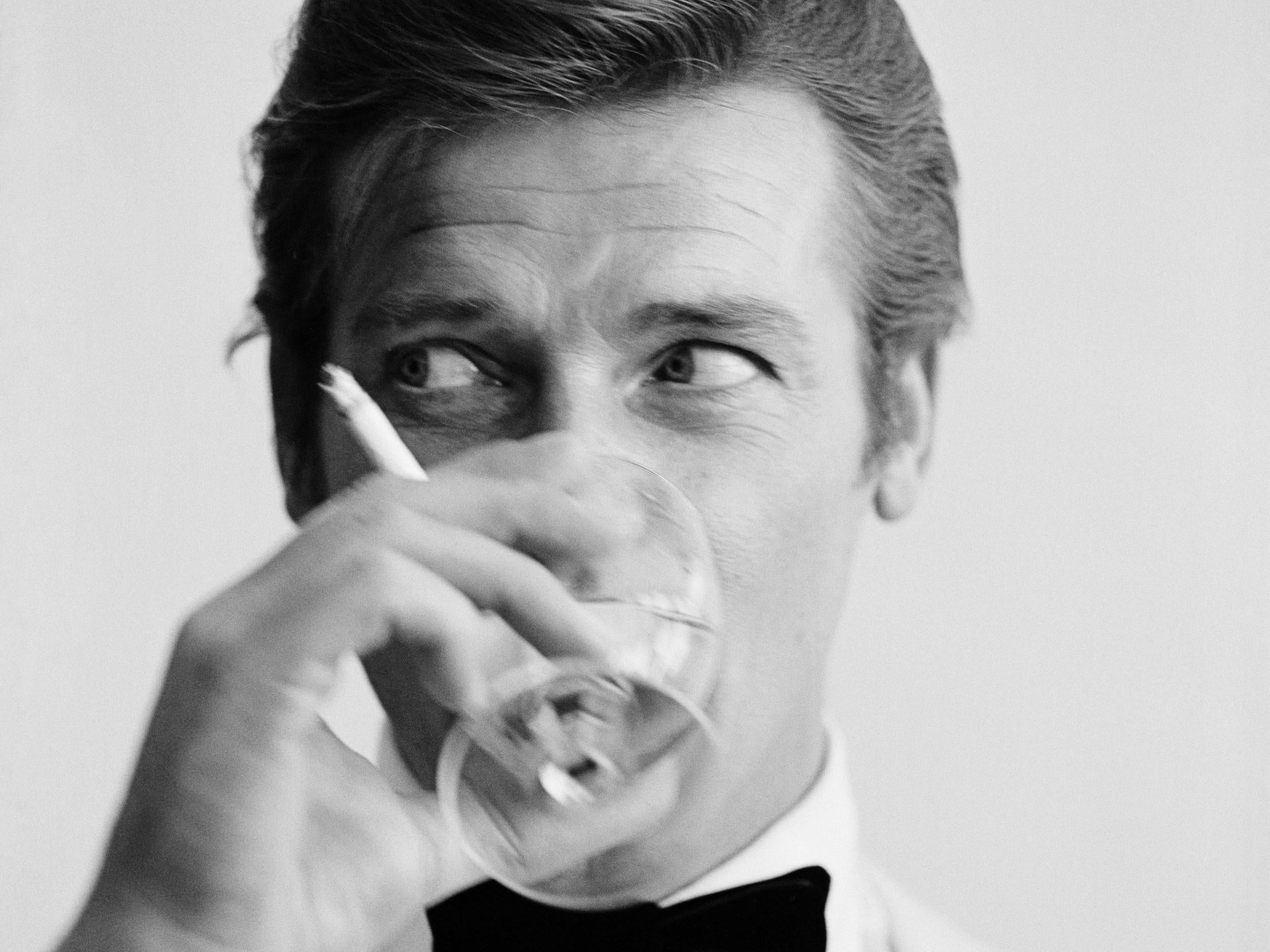 Roger Moore enjoys a cigarette and a martini during a 1968 photoshoot