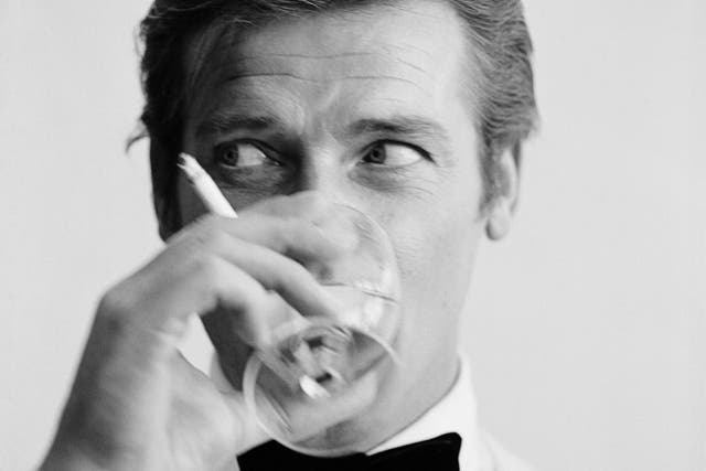 Roger Moore enjoys a cigarette and a martini during a 1968 photoshoot