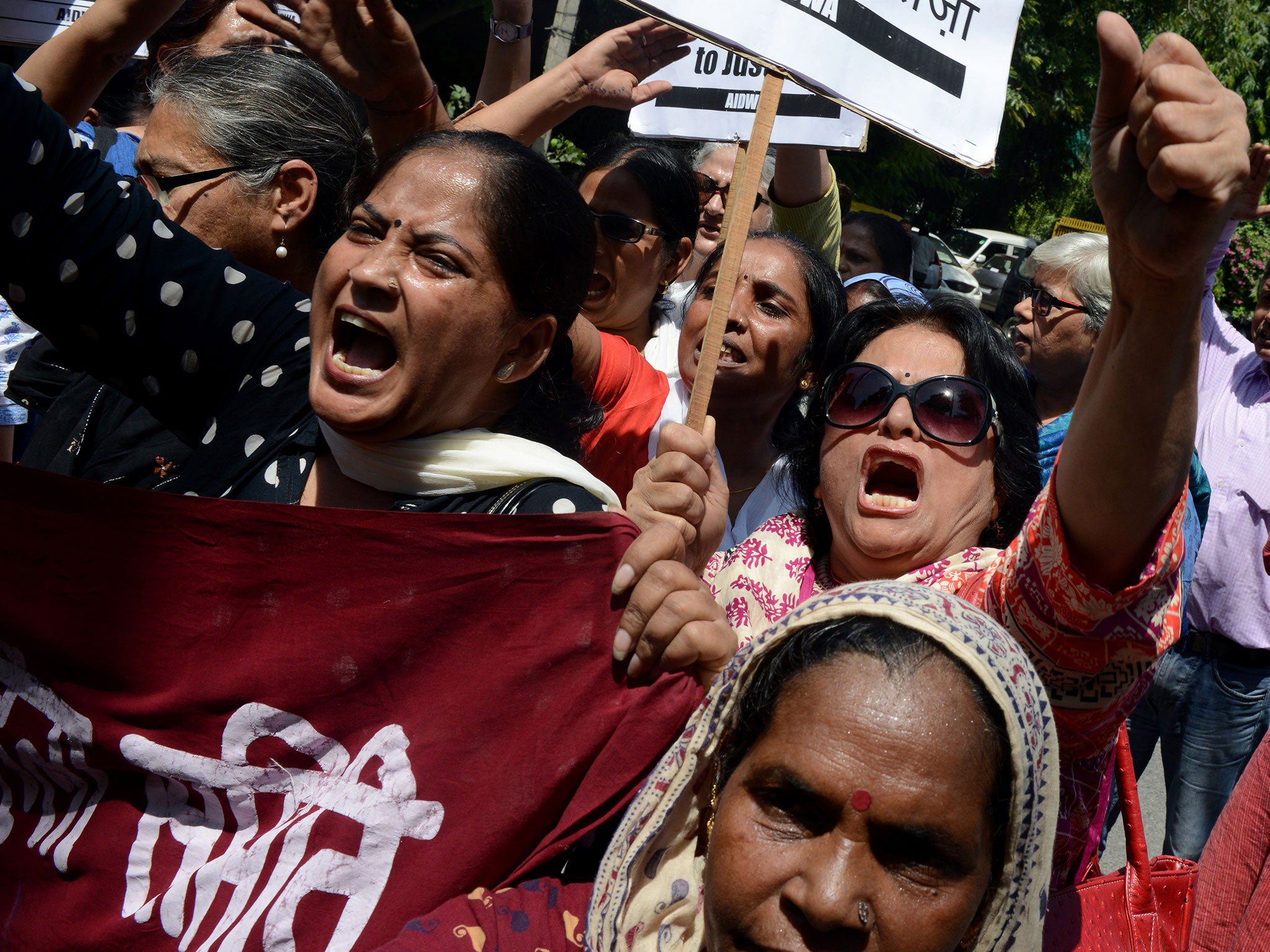 Indian women shout slogans during a protest over claims a Saudi official raped his two maids, near the Saudi Arabian embassy in New Delhi, on 10 September, 2015