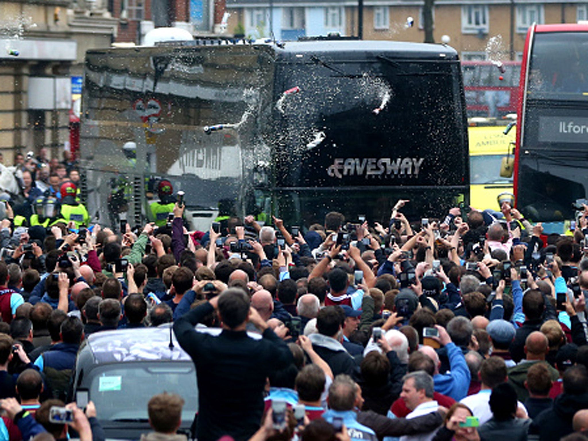 The Manchester United team coach comes under attack from home supporters outside Upton Park on Tuesday night