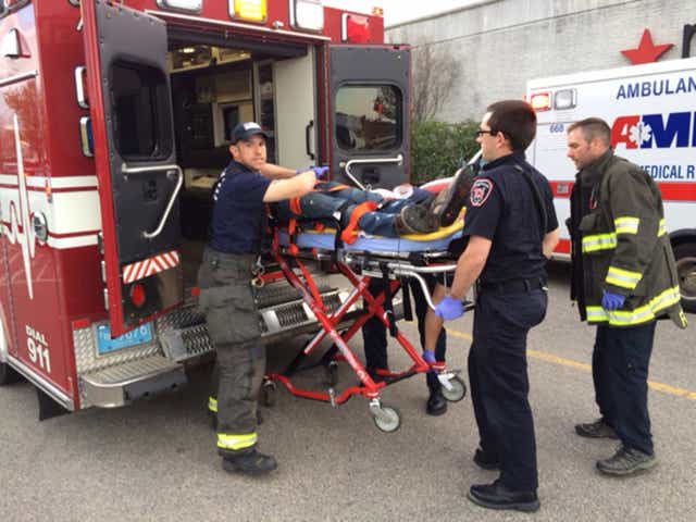 The stabbings suspect is put into an ambulance at Silver City Galleria mall in Taunton, Massachusetts
